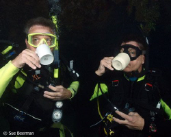 Two divers enjoying their morning coffee at the Halliburt... by Susan Beerman 